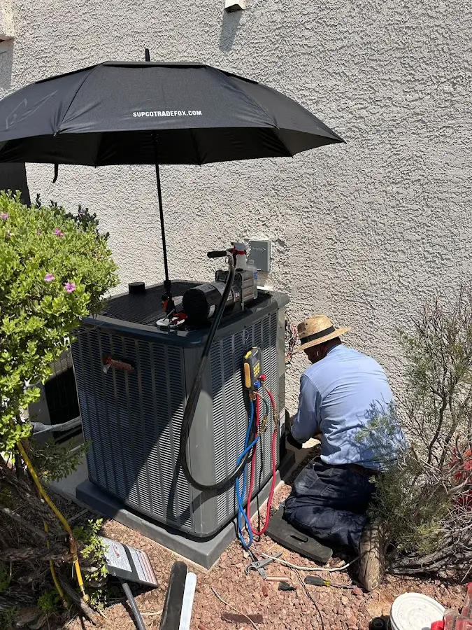 HVAC technician performing outdoor AC maintenance in Bennington